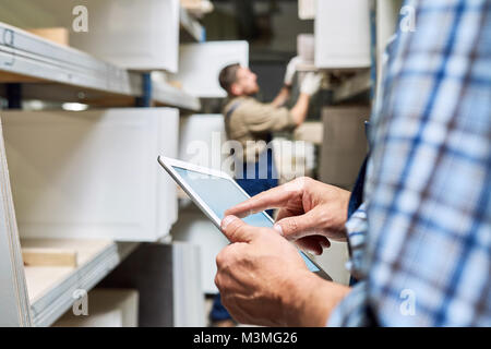 Workers using Digital Tablet in Warehouse Stock Photo