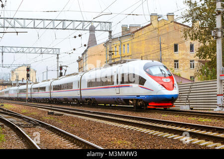 Modern hybrid electric locomotive Sapsan pulling a high-speed train on rails. Technical railway depot. Transport route Saint-Petersburg - Moscow, Russ Stock Photo