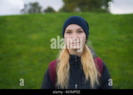 portrait of teen girl against green field Stock Photo
