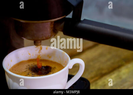 Coffee maker with coffee cup process of being made in a cafe Stock Photo