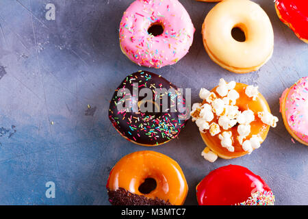 sweet doughnuts on gray stone background Stock Photo