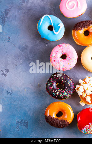sweet doughnuts on gray stone background Stock Photo