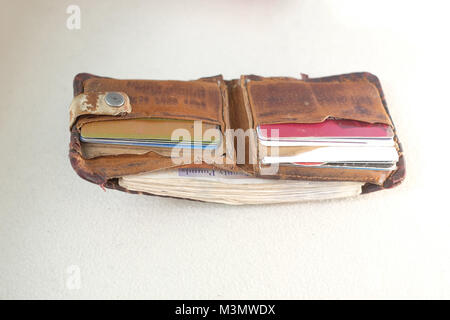 February 2018 - Old leather wallet stuffed with British cash, so it can't close properly. Wallet was hand made in Uganda out of goat skin. Stock Photo