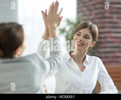 members of the business team giving each other a high five. Stock Photo