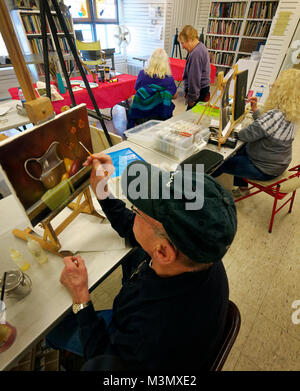 Retirees enjoy life by getting out  taking painting classes and being creative at the Trinity Arts Guild in Texas. Taking on a new challenge is fun and makes new friends. Stock Photo