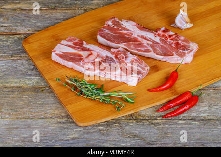 veal lamb steak on the bone of raw cutlets with aromatic herbs, spices and vegetables Stock Photo