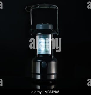 Camping lamp isolated on white background with copy space for text. Electric LED lantern with compass and handle Stock Photo