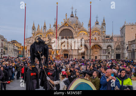 VENICE, ITALY - FEBRUARY 11: People wearing costumes attend the traditional events of Carnival 'Cutting off the Bull's head' and 'Dance of the Masks'  Stock Photo