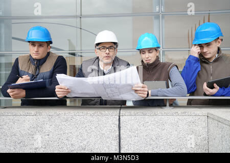 Instructor with young people in engineering training Stock Photo