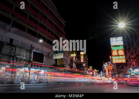 Night time light trails of cars rear lights heading in to the China town district of Bangkok Thailand. Stock Photo