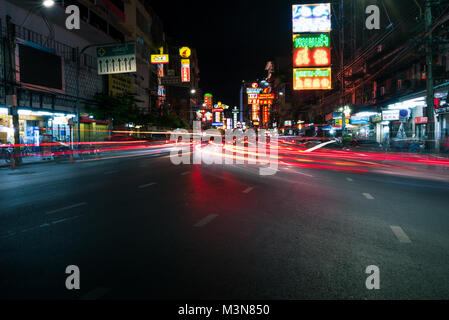 Night time light trails of cars rear lights heading in to the China town district of Bangkok Thailand. Stock Photo