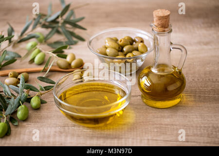 Extra virgin healthy Olive oil with fresh olive on wooden background Stock Photo