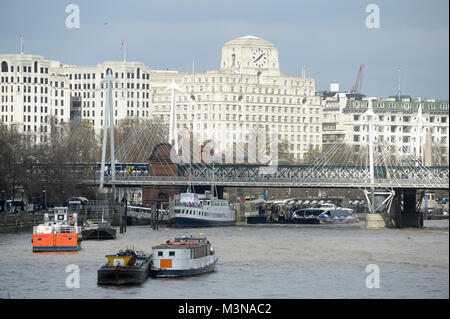 Hungerford Bridge and The Golden Jubilee Bridge on River Thames, Art Deco style building New Adelphi from 1930 and art deco style office building Shel Stock Photo