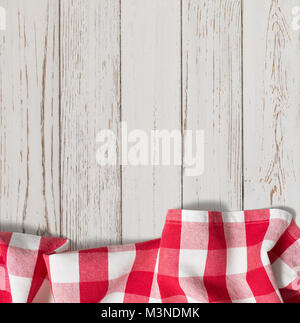 red checkered picnic tablecloth on white wood table Stock Photo
