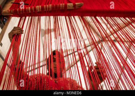 Muslim woman working weaving wooden traditional weaver Morocco High Atlas Stock Photo