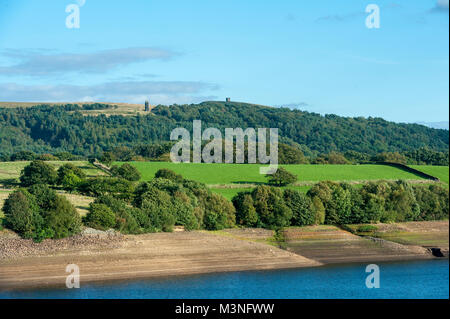 View of the famous Lancashire landmark of Rivington Pike and Pigeon Tower in the former Leverhulme Gardens taken from accross the Yarrow Reservoir in  Stock Photo