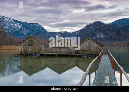 Boathouses at lake Kochelsee, Bavaria, Germany, on a winter evening Stock Photo