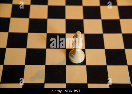 White queen on empty chess board. Stock Photo