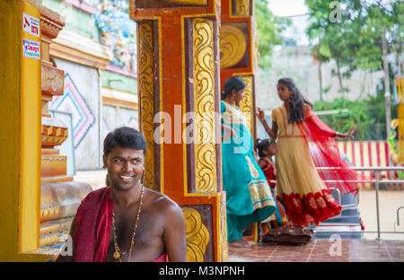 Dambulla Kandy road Sri Muthumariamman Temple Sri Lanka kovil man women saree smiling Stock Photo