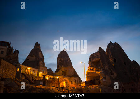 Night scene of the Uchisar Castle in Cappadocia. Illuminated view of famous Uchisar village, district of Nevsehir Province in the Central Anatolia Region of Turkey, Asia. Stock Photo