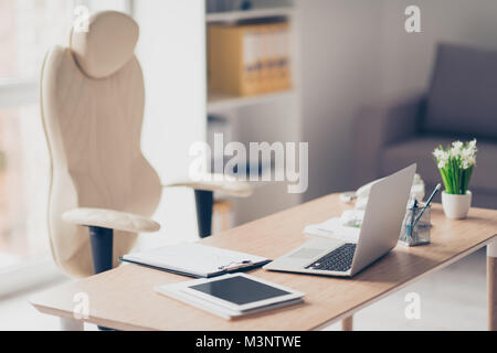 Empty office with modern luxurious fashionable interior, comfortable armchair, desktop with necessary equipment ans computer Stock Photo