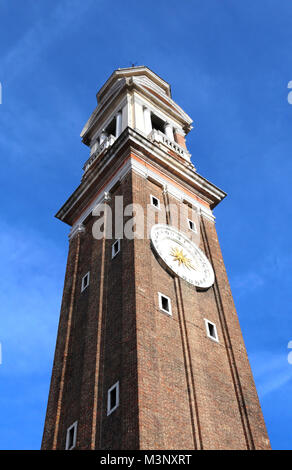 High bell tower of the Church of SANTI APOSTOLI in Venice Italy Stock Photo