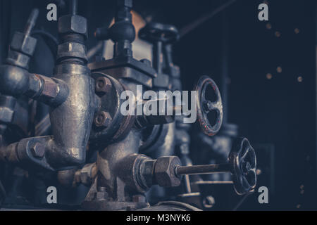 vintage machinery, pipes and valves inside old factory Stock Photo