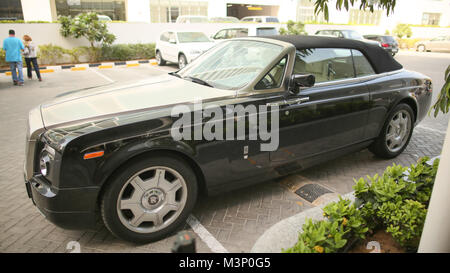 DUBAI, UAE - AUGUST 20, 2014: Black Rolls Royce on Dubai Street. UAE. Stock Photo