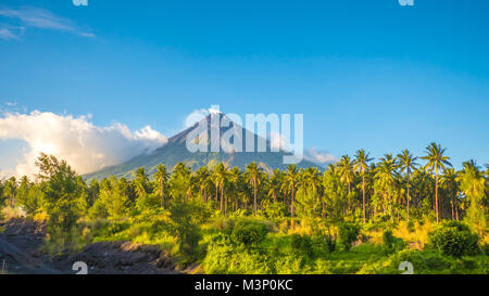 Mayon Volcano is an active stratovolcano in the province of Albay in Bicol Region, on the island of Luzon in the Philippines. Renowned as the perfect cone because of its symmetric conical shape. Stock Photo