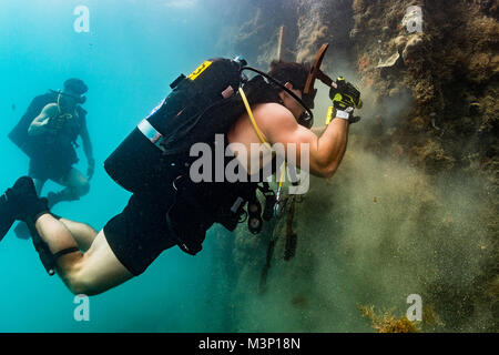 U.S. Navy Diver 2nd Class Logan Peters, assigned to Mobile Diving Salvage Unit (MDSU) 1, conducts an underwater pier survey with divers from Underwater Construction Team (UCT) 2 in Apra Harbor, Guam, Dec 14, 2017.  UCT-2 provides construction, inspection, maintenance, and repair of underwater and waterfront facilities in support of the Pacific Fleet. (U.S. Navy Combat Camera photo by Mass Communication Specialist 1st Class Arthurgwain L. Marquez) U.S. Navy divers conduct underwater pier survey in Apra Harbor, Guam by #PACOM Stock Photo