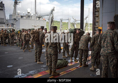 180201-N-WF272-102 WHITE BEACH, Okinawa (Feb. 1, 2018) Marines, assigned to the 3d Marine Division (MARDIV), embark the amphibious assault ship USS Bonhomme Richard (LHD 6). Bonhomme Richard is operating in the Indo-Asia-Pacific region as part of a regularly scheduled patrol and provides a rapid-response capability in the event of a regional contingency or natural disaster. (U.S. Navy photo by Mass Communication Specialist 2nd Class Diana Quinlan/Released) Marines embark USS Bonhomme Richard in Okinawa for a scheduled patrol by #PACOM Stock Photo