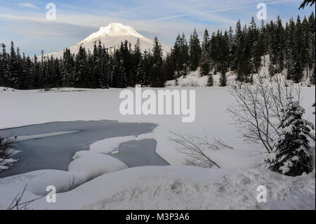 Trillium Lake seen frozen over during the winter in Mt. Hood National Forest in Oregon. Stock Photo