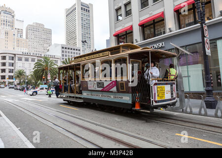 SAN FRANCISCO Ca. - JUNE 16: Passengers ride in a cable car  JUNE 16, 2015 in San Francisco. It is the most popular way to get around the City of San 