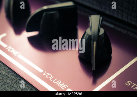 Retro guitar amplifier close up shot, volume set to maximum Stock Photo