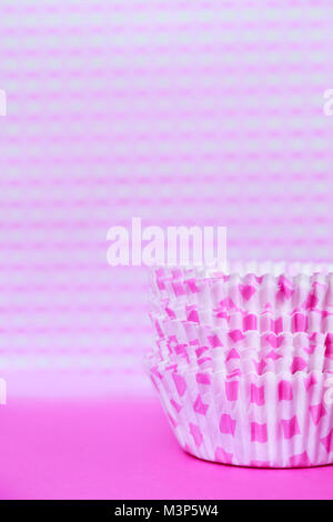 Violet paper baking cups on violet background Stock Photo