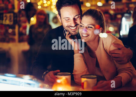 Romantic couple dating in pub at night Stock Photo