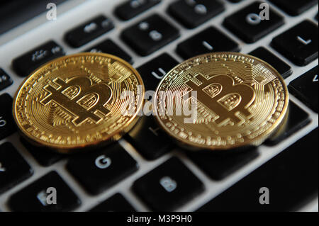 Bitcoins on a computer keyboard Stock Photo