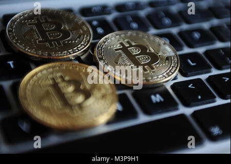 Bitcoins on a computer keyboard Stock Photo
