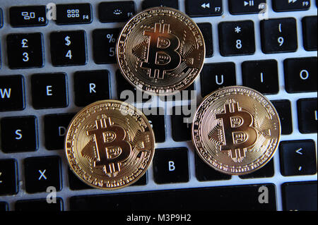 Bitcoins on a computer keyboard Stock Photo