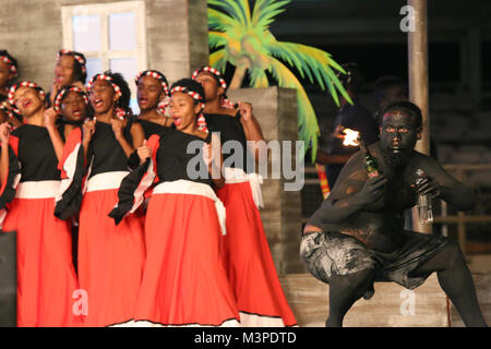 Trinidad, Port of Spain. 11th Feb, 2018. Singers and a  traditional mas character during a performance at the Dimanche Gras show in the Queen's Park Savannah on Feb 11, 2018 in Port of Spain, Trinidad.  (Photo by Sean Drakes/Alamy Live News) Credit: SEAN DRAKES/Alamy Live News Stock Photo