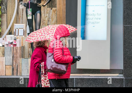 Preston, Lancashire. 12th Feb 2018. UK Weather: Cold, wet and snowy start to the day. Rain and snow showers have swept across the north of England overnight. Intense showers continue to cover the region drenching shoppers in the city centre. Credit: MediaWorldImages/Alamy Live News Stock Photo