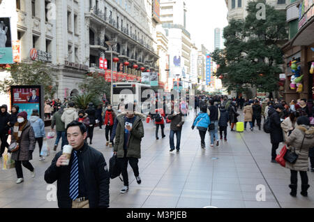 Shanghai, China. 12th February 2018. Most important holiday in China: Chinese New Year, Year of Dog. Chinese families enjoying shopping in Nanjing Road on 12th February. Credit: Bartlomiej Magierowski/Alamy Live News Stock Photo