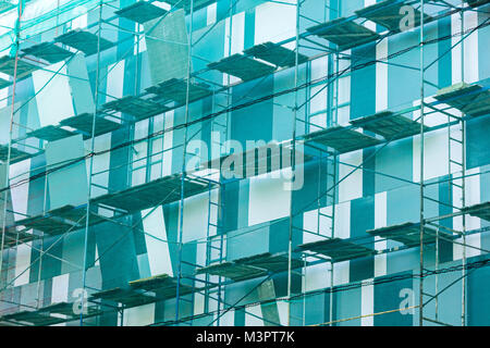 scaffolding on building facade. fall-protection safety net. building facade renovation. Stock Photo