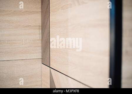 Wooden beige tile background. Close-up of installed tile with natural colored. Stock Photo