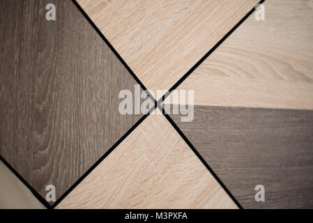 Wooden beige tile background. Close-up of installed tile with natural colored. Stock Photo