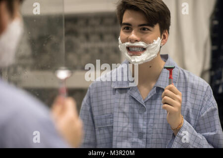 Boy Having Fun while Shaving Face Stock Photo