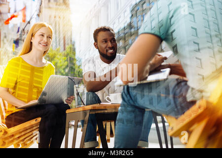 Hardworking colleagues having a productive day and looking happy Stock Photo