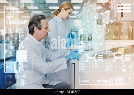 Two colleagues feeling concentrated while working in the laboratory Stock Photo