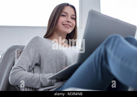 Joyful freelancer enjoying working from home Stock Photo
