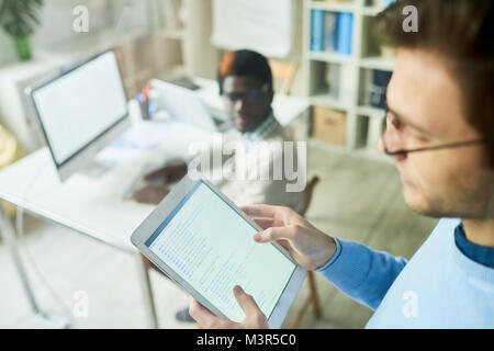 Web Developer Holding Tablet Stock Photo